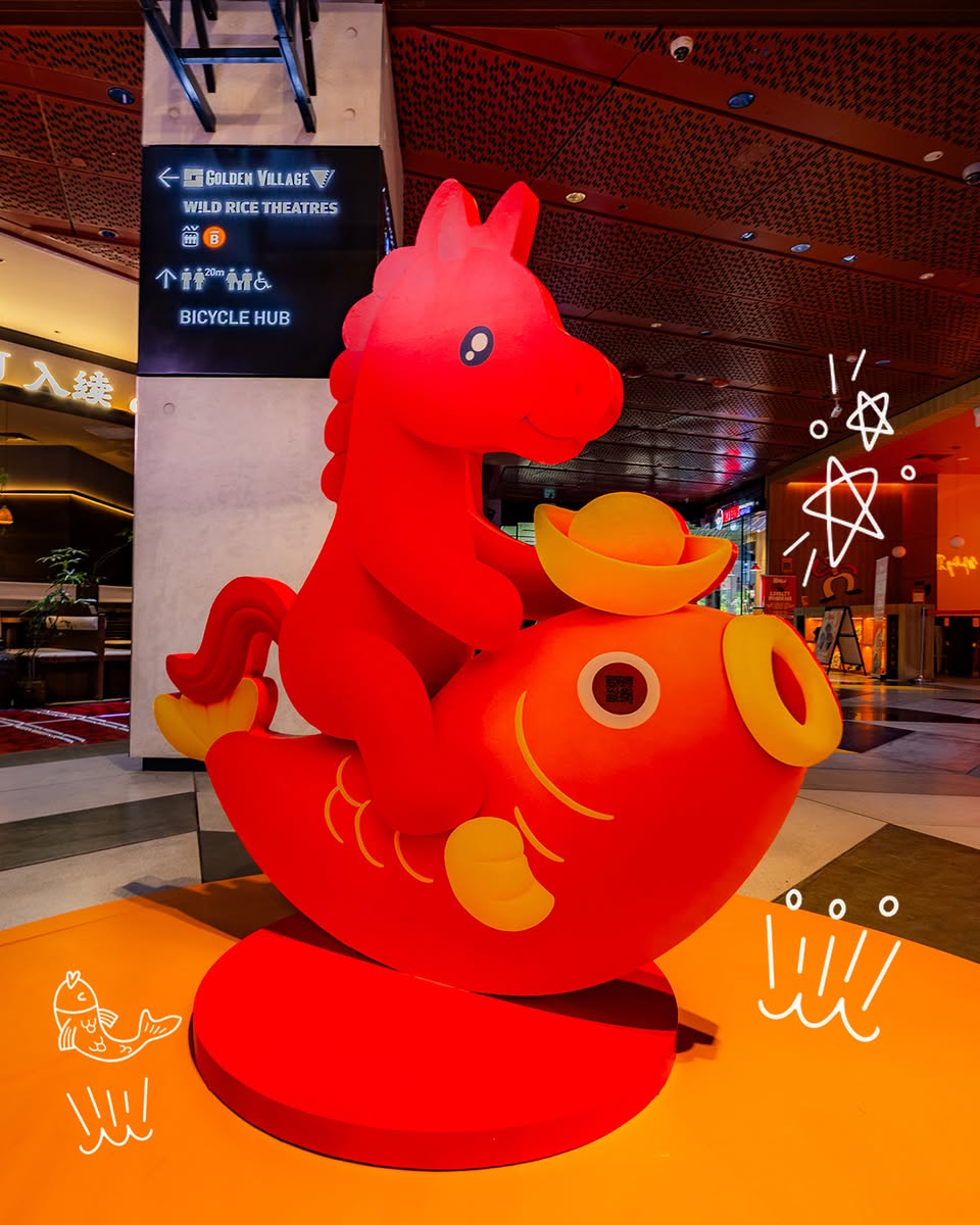 Visitors enjoying the festive photobooth at the Carousel of Prosperity.