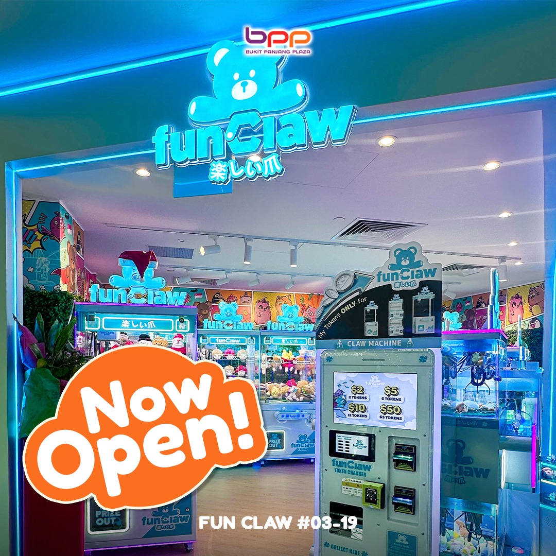 A vibrant claw machine filled with various plush toys and mystery boxes at Fun Claw.