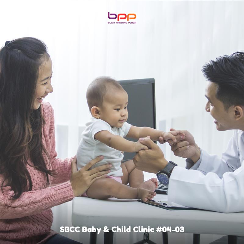 A pediatrician providing gentle care to a young child in a clinic setting