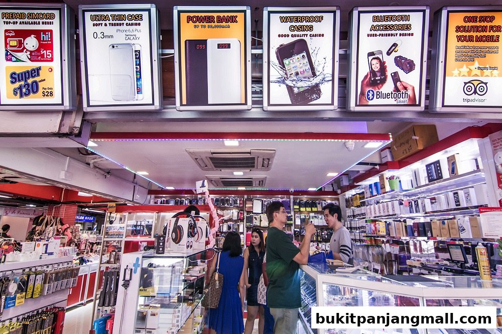 A brightly lit mobile phone accessories shop with various products displayed on shelves and in display cases.