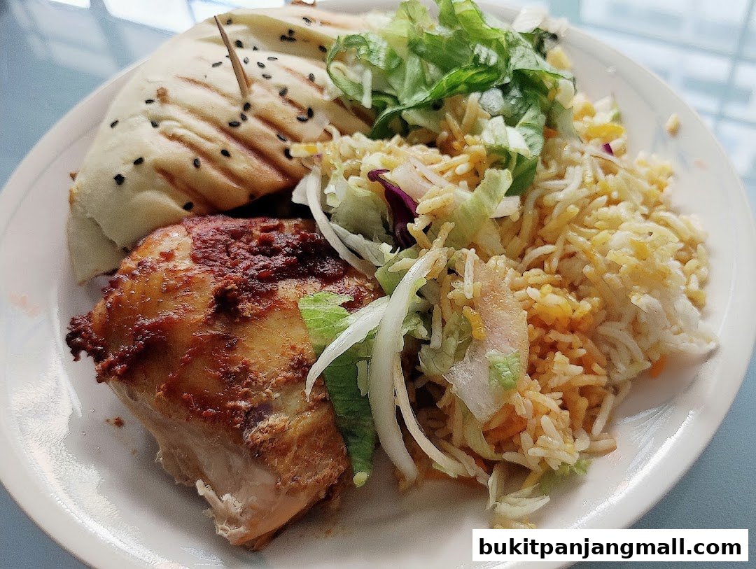 A plate of grilled chicken, rice, salad, and a wrap from ArabiskSG.