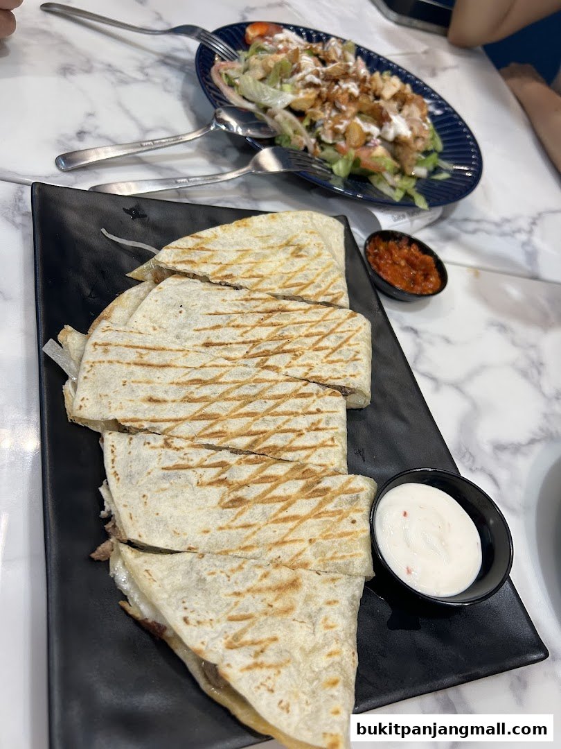 A close-up shot of a delicious quesadilla and a fresh salad at ArabiskSG.