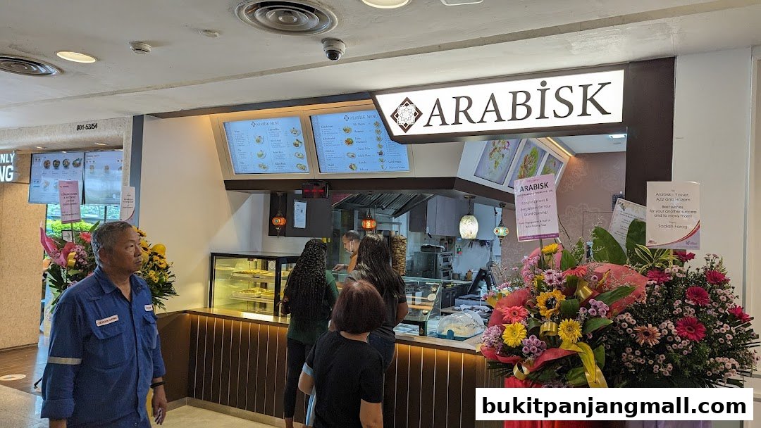 The ArabiskSG shop front with menus displayed and customers ordering.