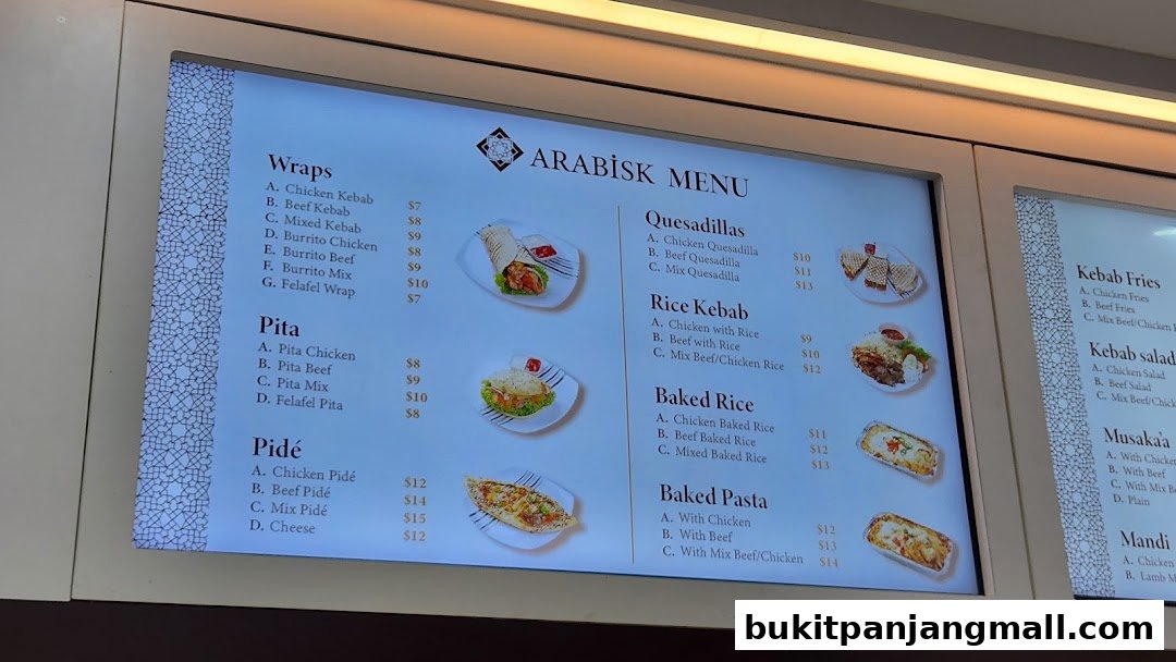 A digital menu board displaying various Arabic food items and their prices.