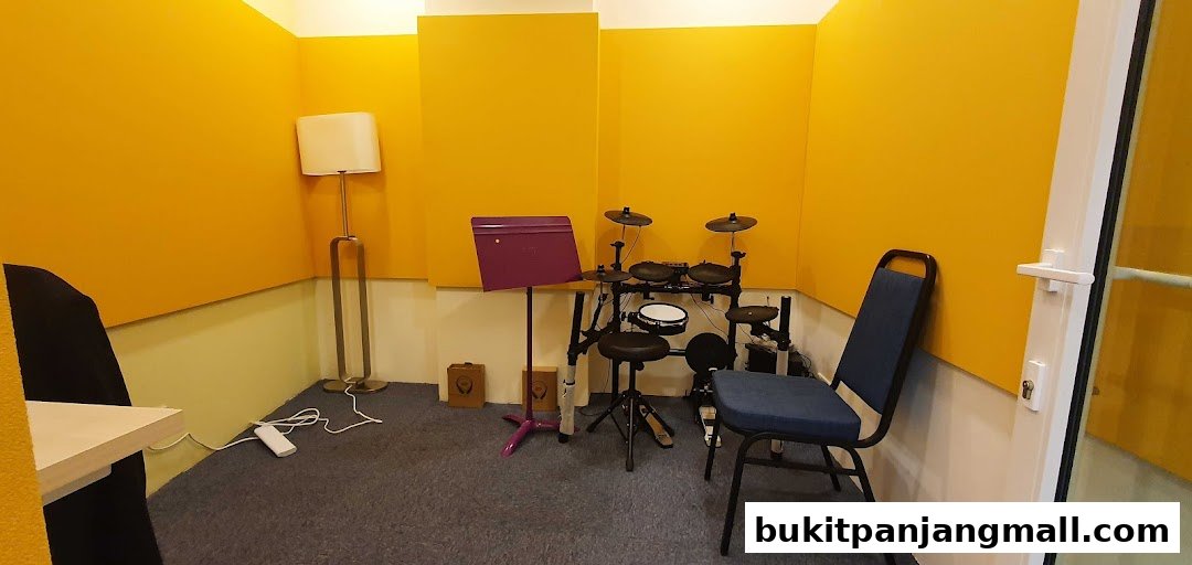 A room with yellow walls, an electronic drum set, a music stand, and a chair.