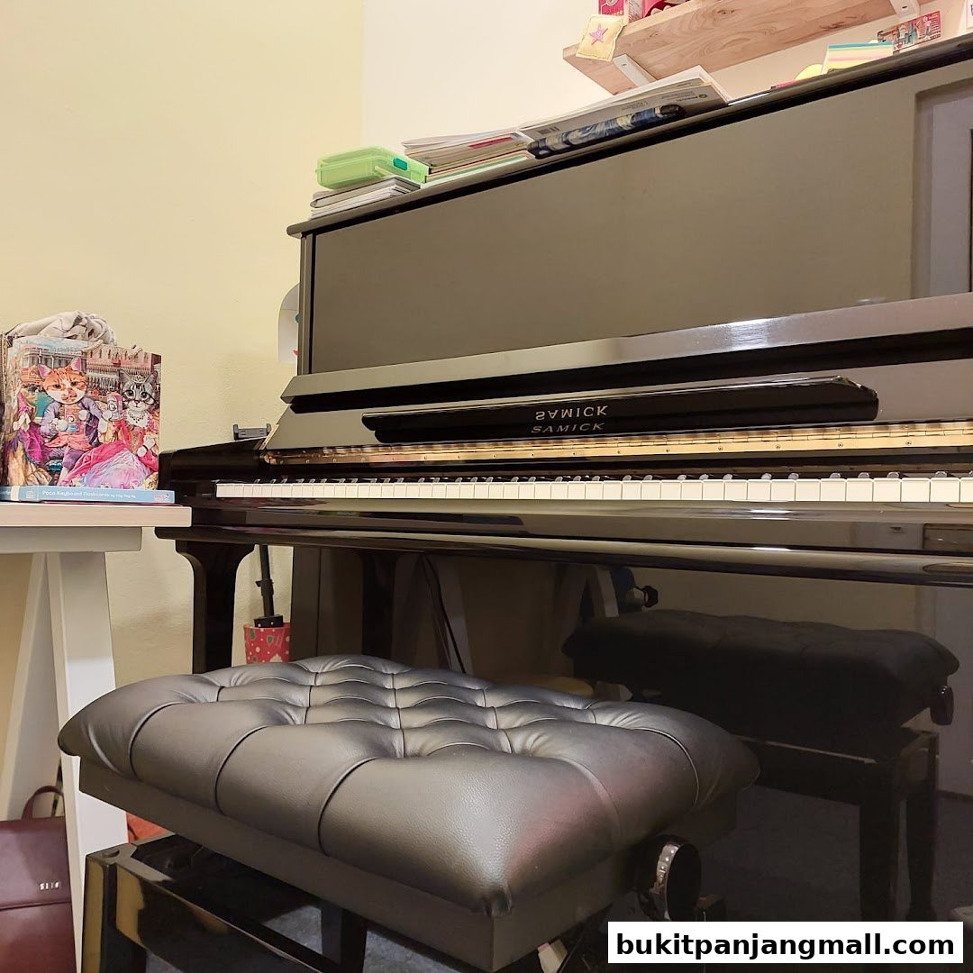 A black upright piano with a tufted bench and sheet music on a table.