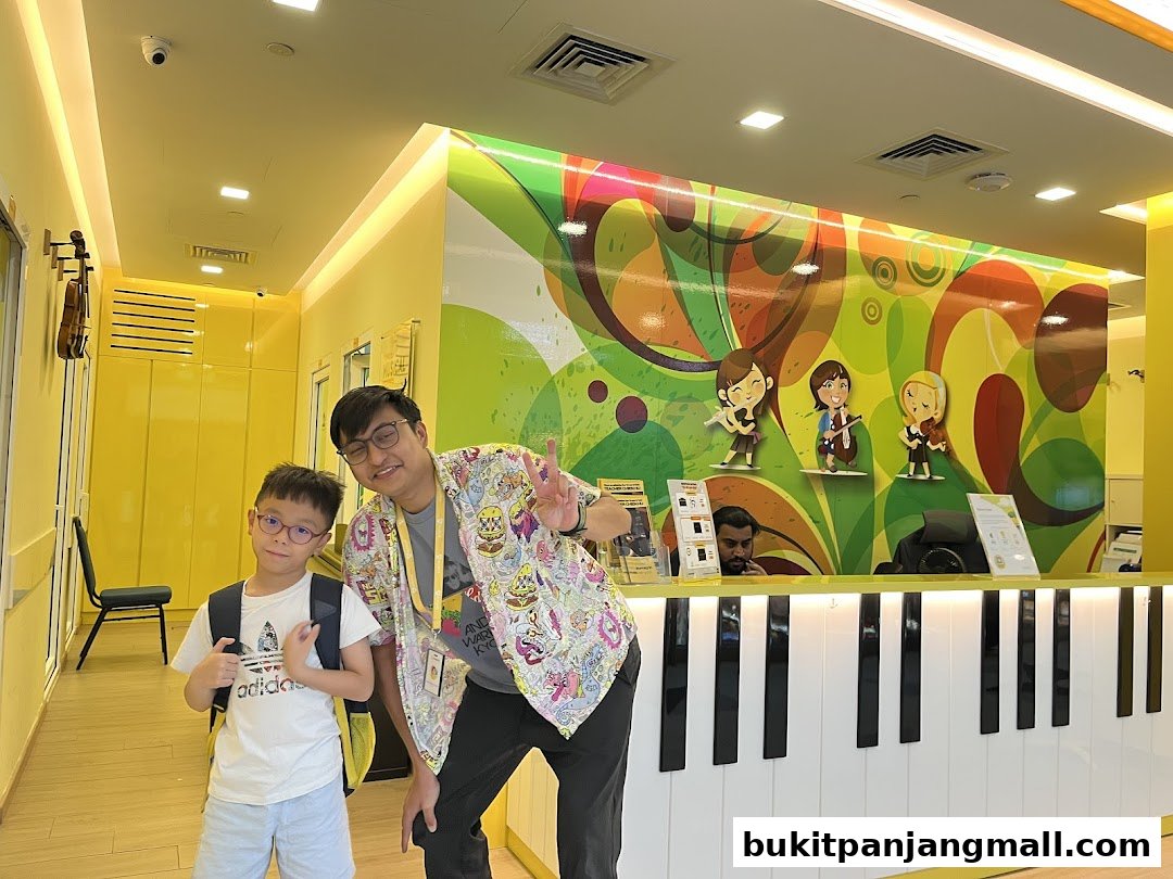 A music academy reception area with a piano-themed counter and cartoon musicians.