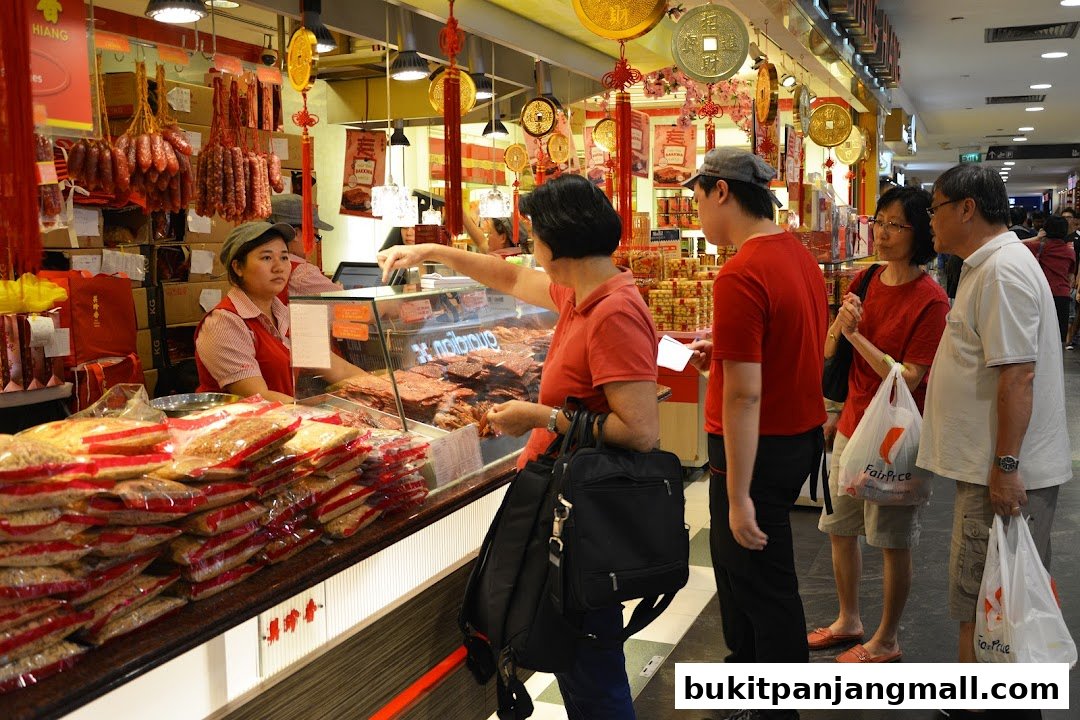 Customers are served at a Bee Cheng Hiang store with various meat products displayed.