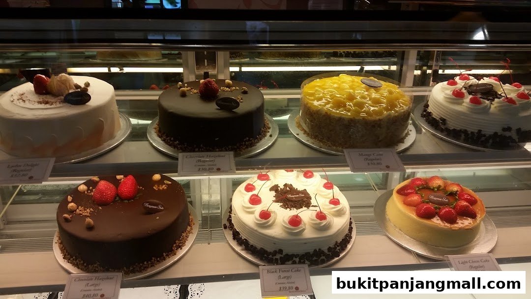 A display case filled with various beautifully decorated cakes from Bengawan Solo.