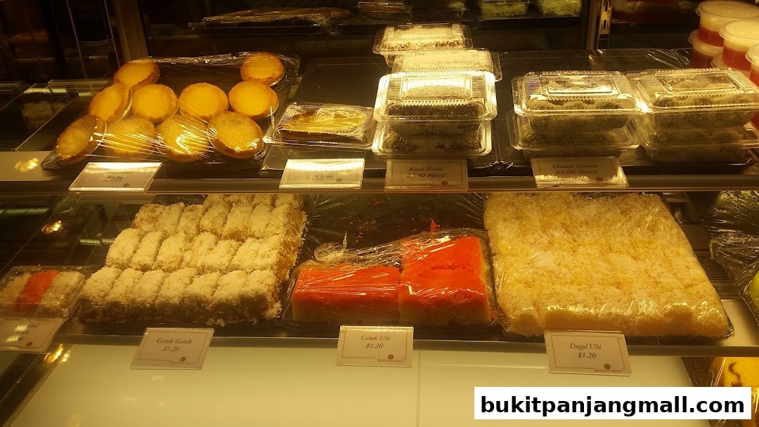 A display case filled with various sweet pastries and desserts, neatly packaged and labeled.