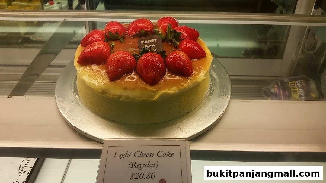 A delicious light cheese cake topped with fresh strawberries and a 'Happy New' chocolate plaque.