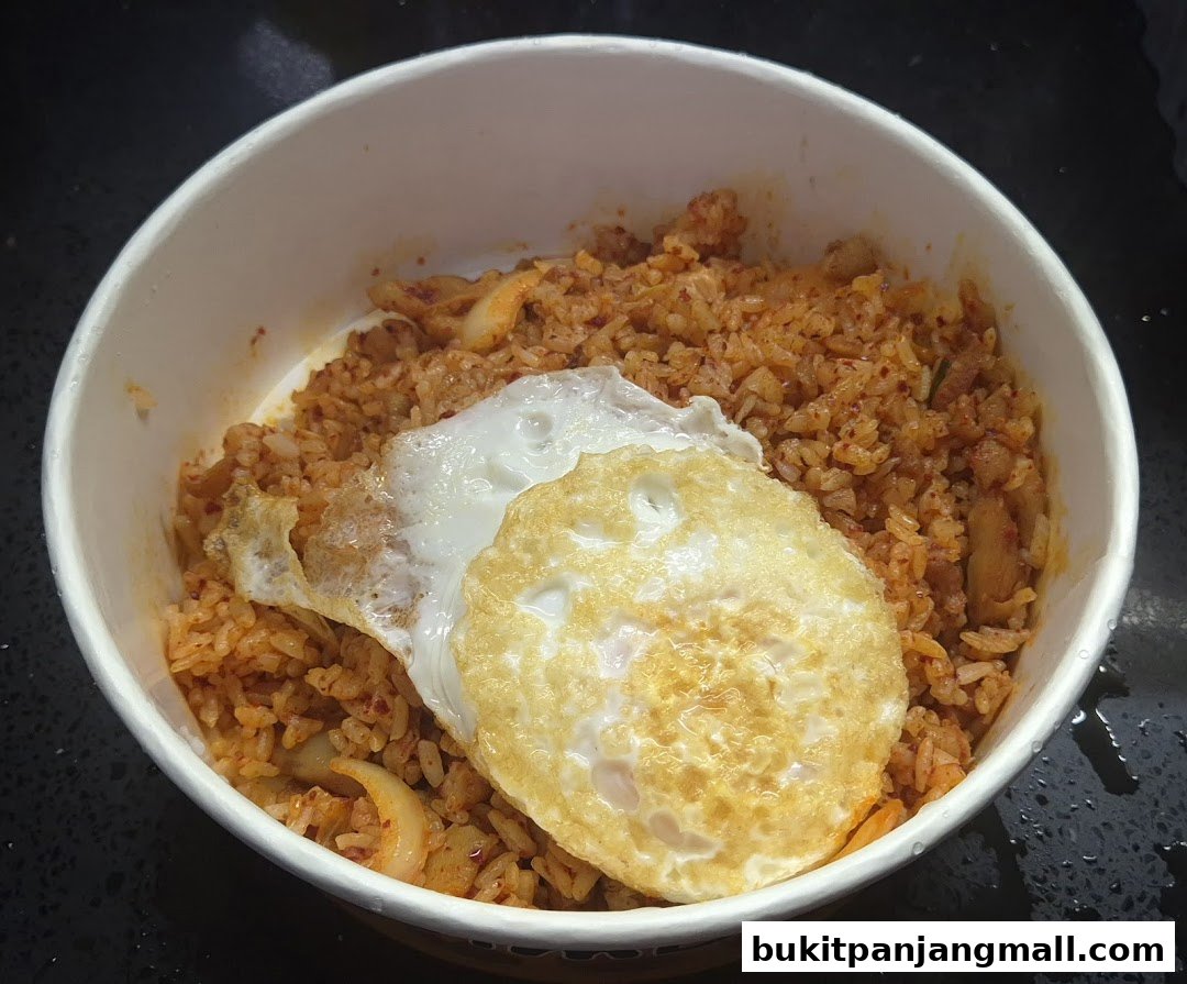 A close-up shot of a delicious bibimbap dosirak with a fried egg on top.