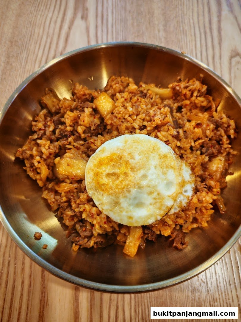 A close-up shot of a delicious bibimbap dish with a fried egg on top.