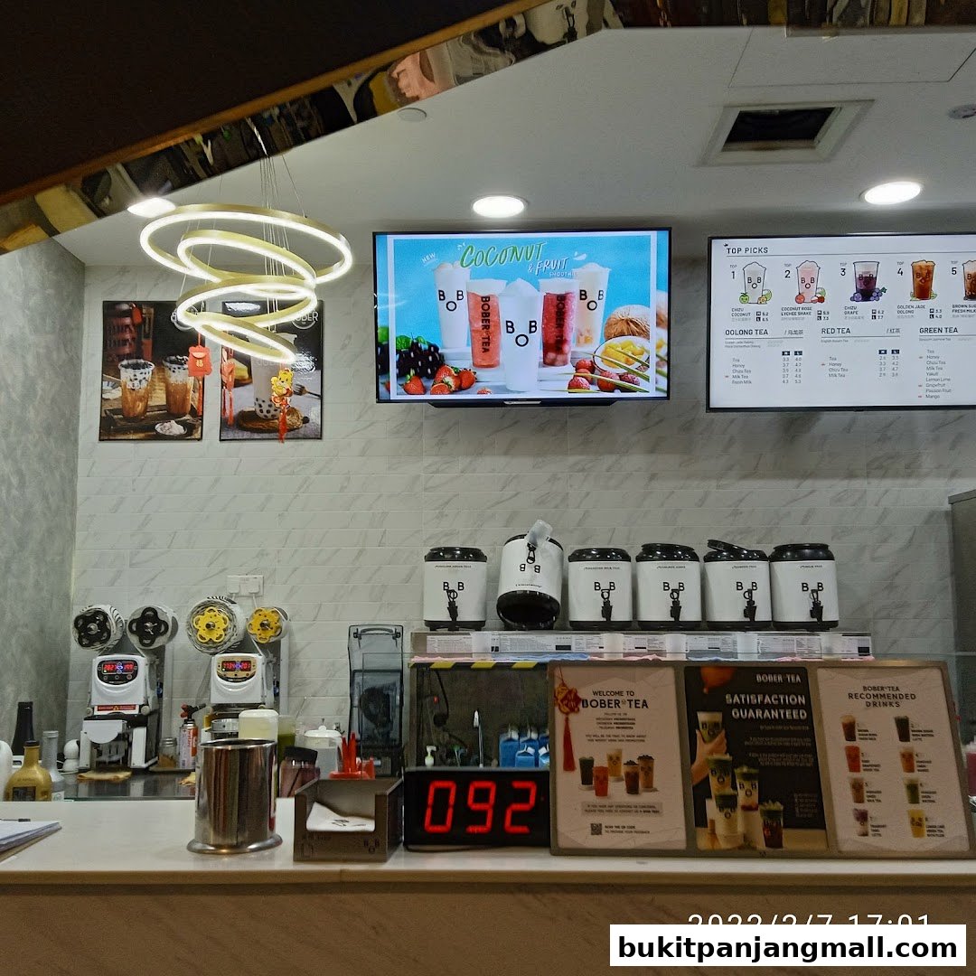 Interior view of a Bober Tea shop with a digital menu, drinks, and equipment.