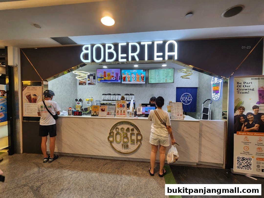 A Bober Tea shop with customers ordering at the counter and a recruitment poster.