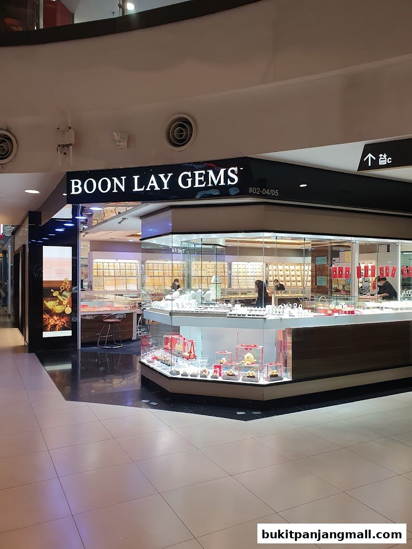 A jewelry store named Boon Lay Gems with display cases filled with gold and gems.