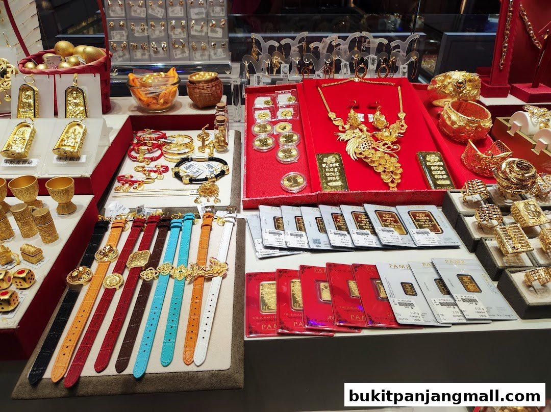 A display of various gold jewelry and gold bars, including necklaces, bracelets, watches, and rings.