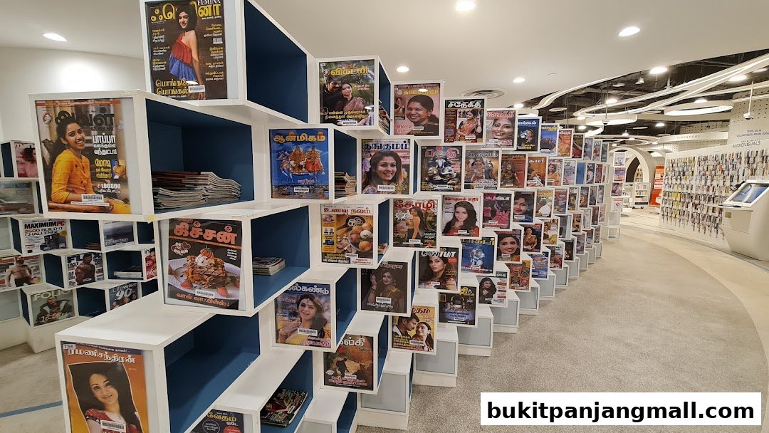 A library section displaying a variety of magazines and books on tiered shelving.