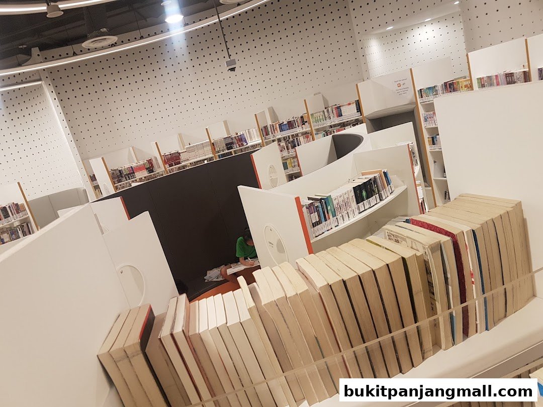 Interior view of a modern library with rows of books and study areas.