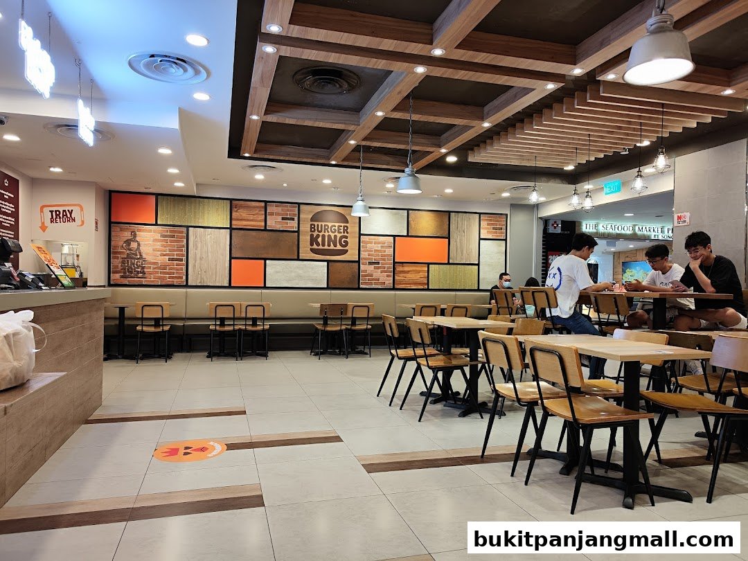 Interior of a Burger King restaurant with seating areas and a counter.