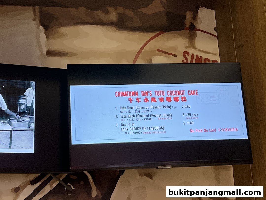 A digital menu board displays prices for Chinatown Tan's Tutu Coconut Cake.