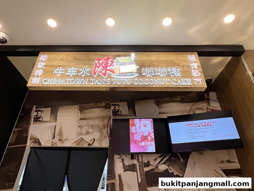 Shop front sign for Chinatown Tan's Tutu Coconut Cake with a menu display.