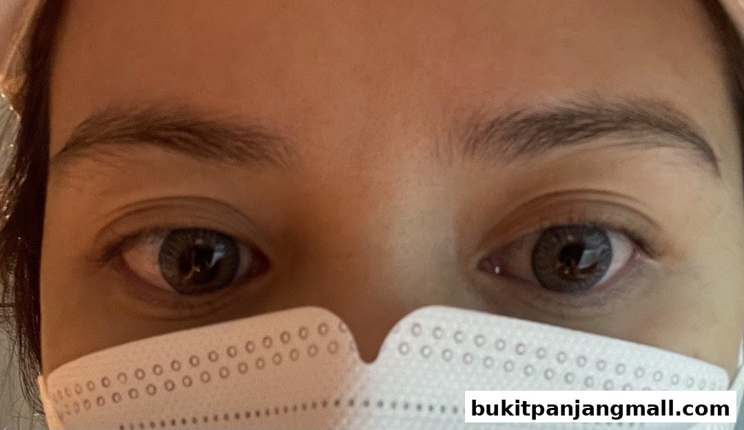 Close-up of a person's eyes and a white mask, likely before or after a beauty treatment.