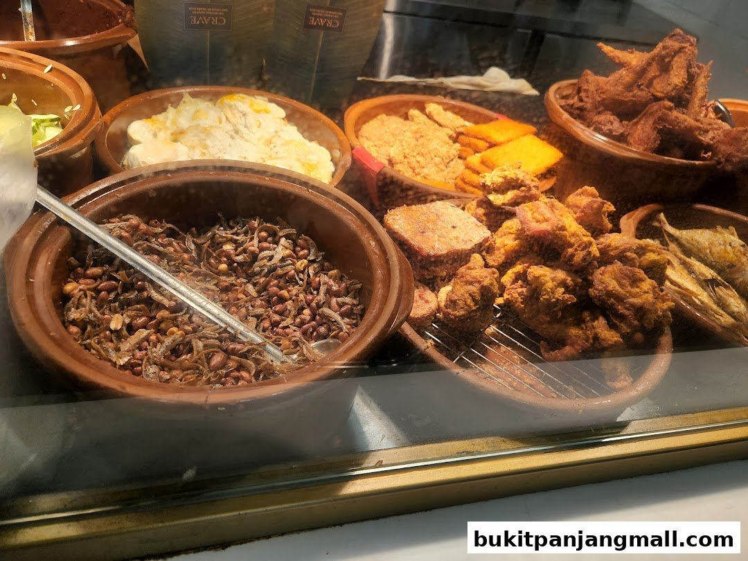 A display of various fried foods and side dishes in clay pots at a restaurant.