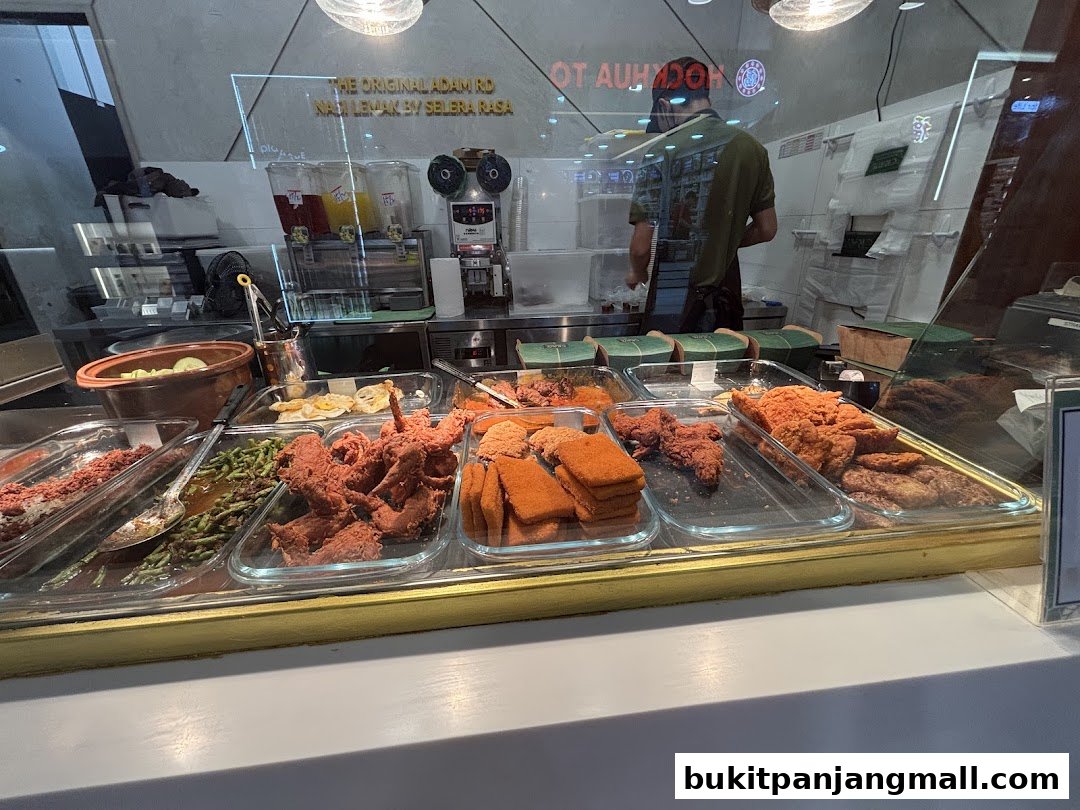 A display of various nasi lemak dishes, including fried chicken and side dishes.