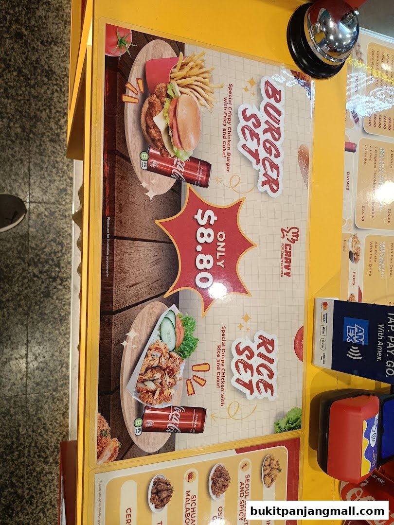 A menu board displaying a Burger Set and a Rice Set from Cravy Chicken.