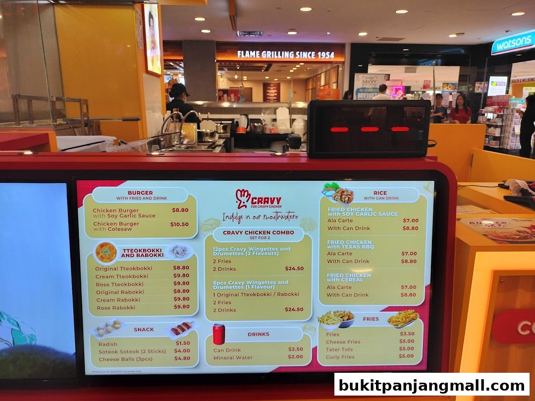 A digital menu board displaying various Korean fried chicken, tteokbokki, and snack options.