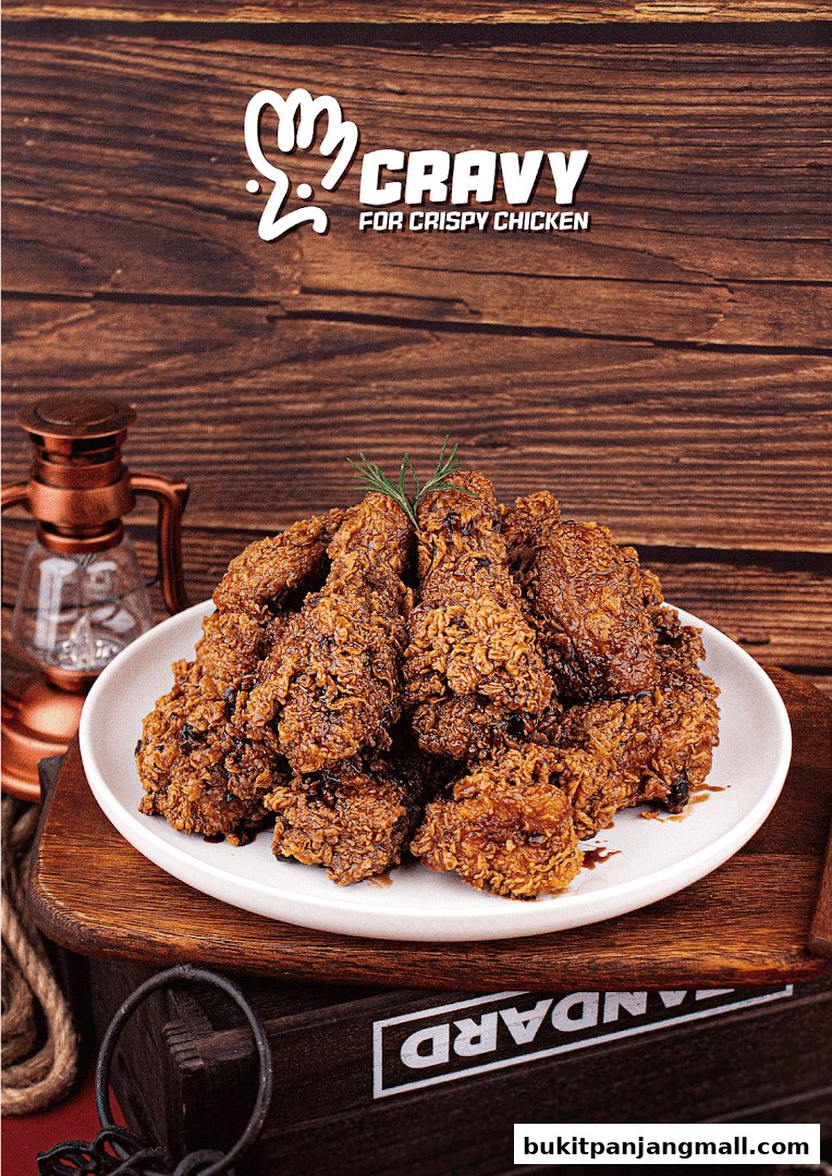A plate of crispy Korean fried chicken with a sprig of rosemary, presented on a wooden surface.