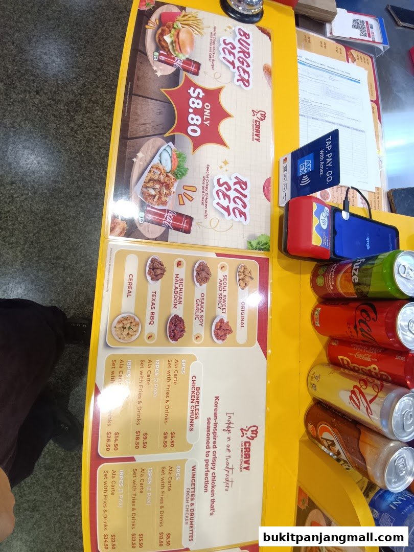 A menu board for Cravy Chicken featuring burger and rice sets, chicken chunks, and wingettes.