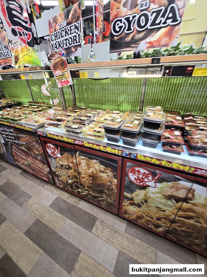 A display of pre-packaged Japanese food items like yakitori and gyoza, ready for purchase.