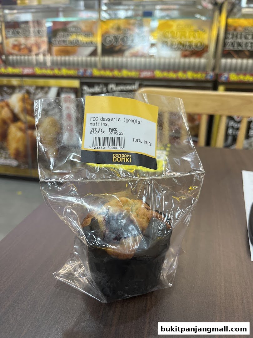 A packaged muffin from DON DON DONKI with a price and expiry date label.