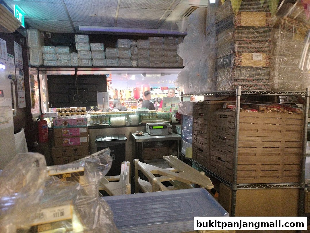 Interior view of a retail store with stacked products, shelves, and a counter area.