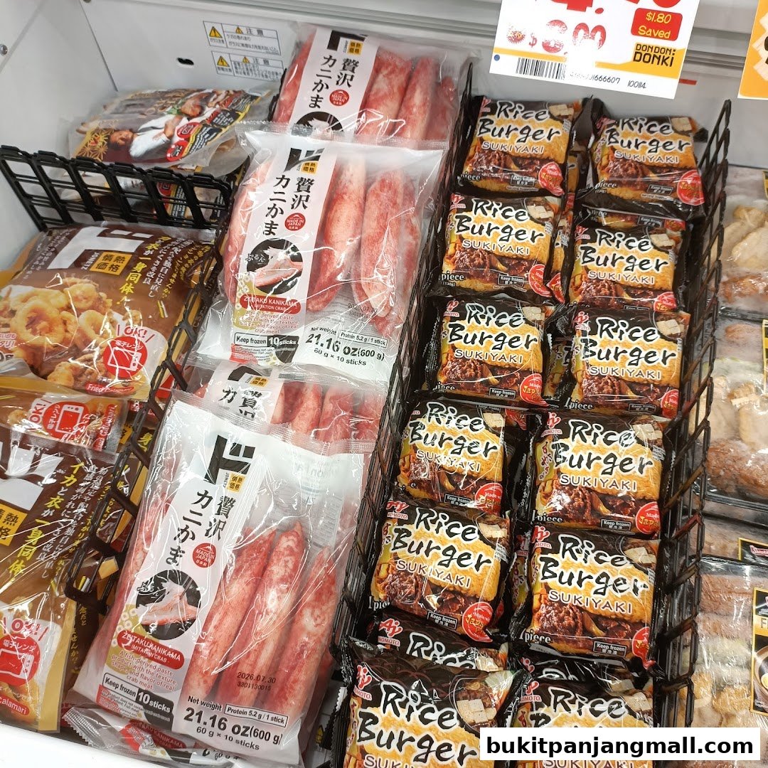 A display of frozen food products, including crab sticks and rice burgers, in a supermarket freezer.