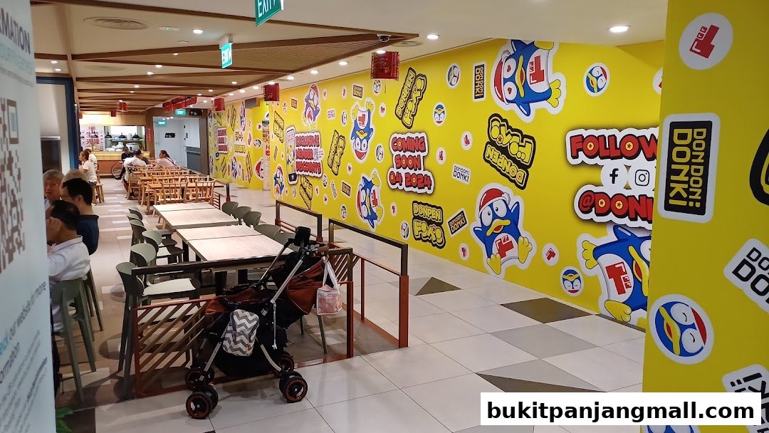 Interior of DON DON DONKI Bukit Panjang Plaza with colorful wall decorations and seating areas.