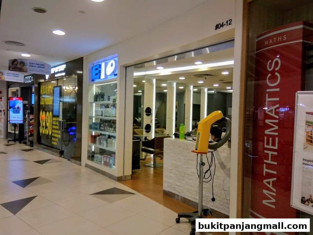 The entrance to E1O Hair Studio, showcasing shelves of hair products and a hair dryer.