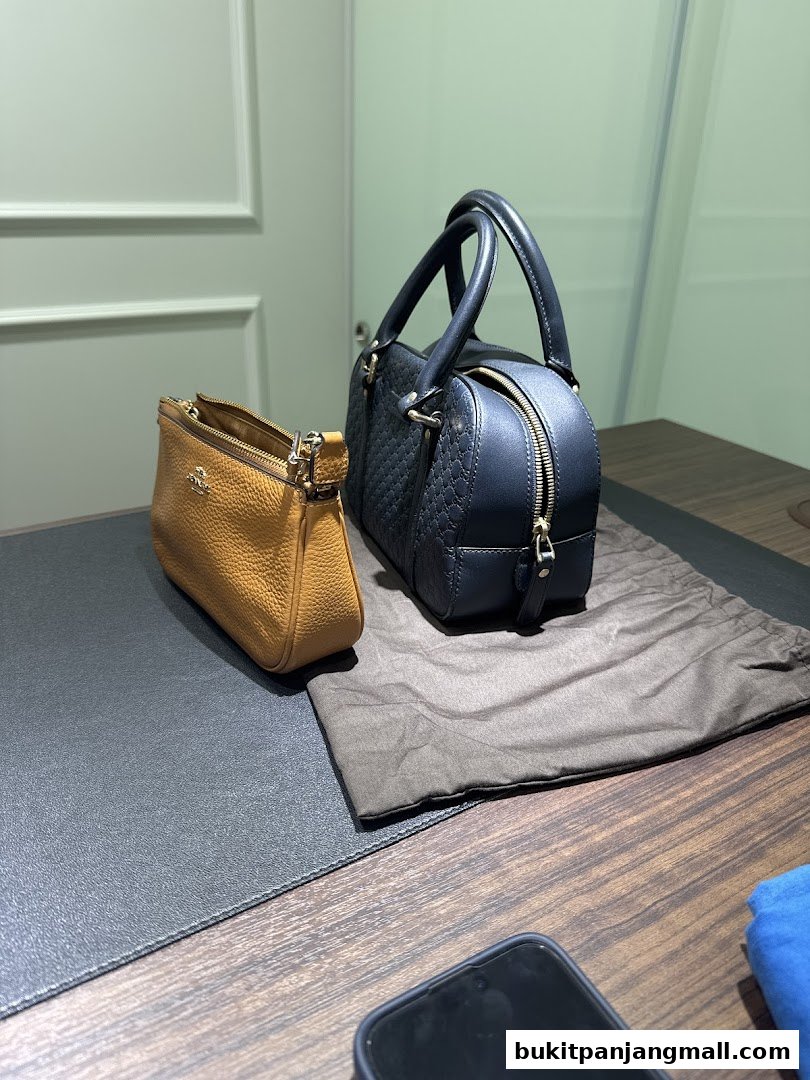 Two stylish handbags, one brown and one black, displayed on a wooden surface.