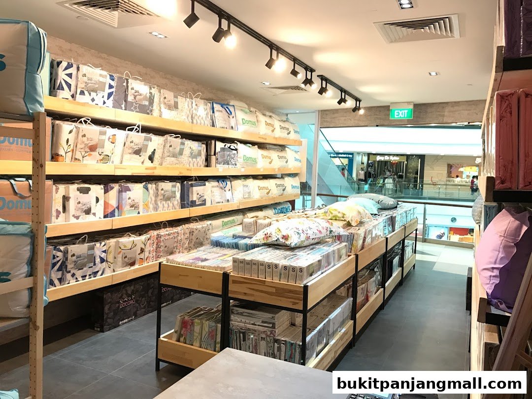 Interior view of a bedding store with shelves stocked with packaged duvets, pillows, and bedding sets.