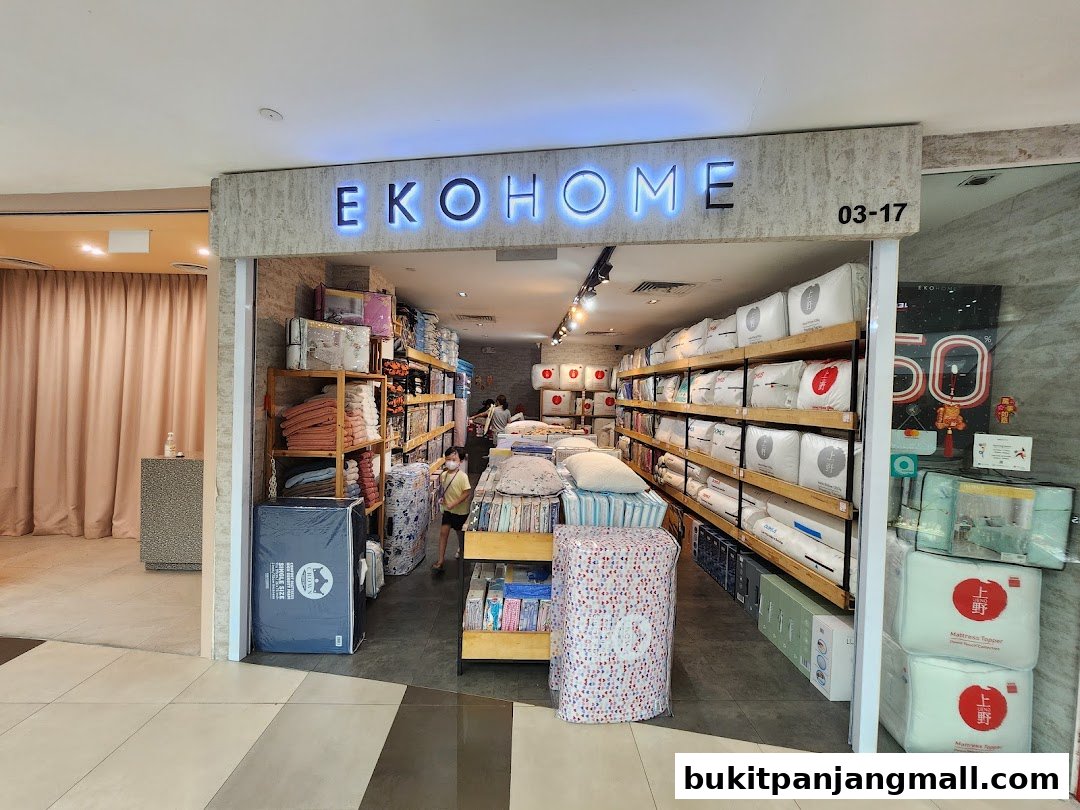 The entrance of Ekohome Pte Ltd, a bedding and home goods store, showcasing various products.