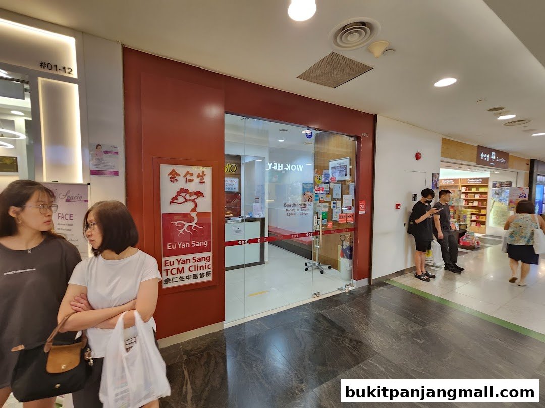 The entrance of Eu Yan Sang TCM Clinic with people standing nearby.