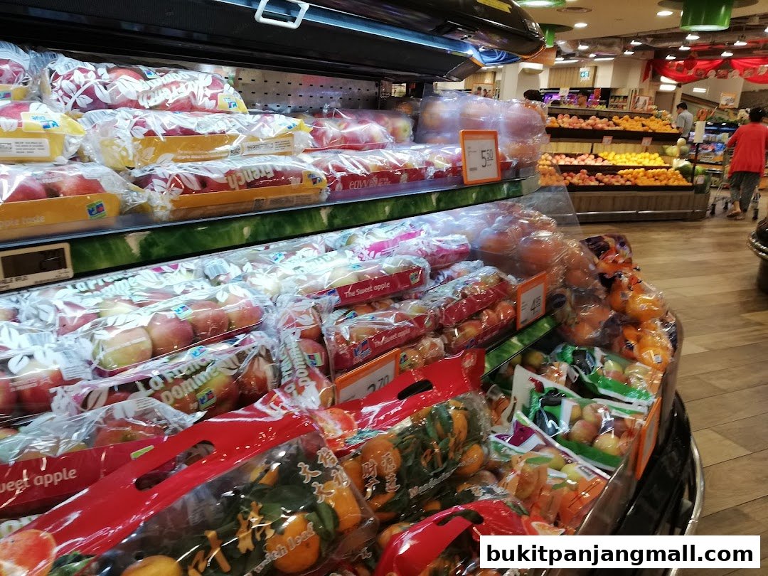 A display of fresh apples and oranges packaged for sale in a supermarket.