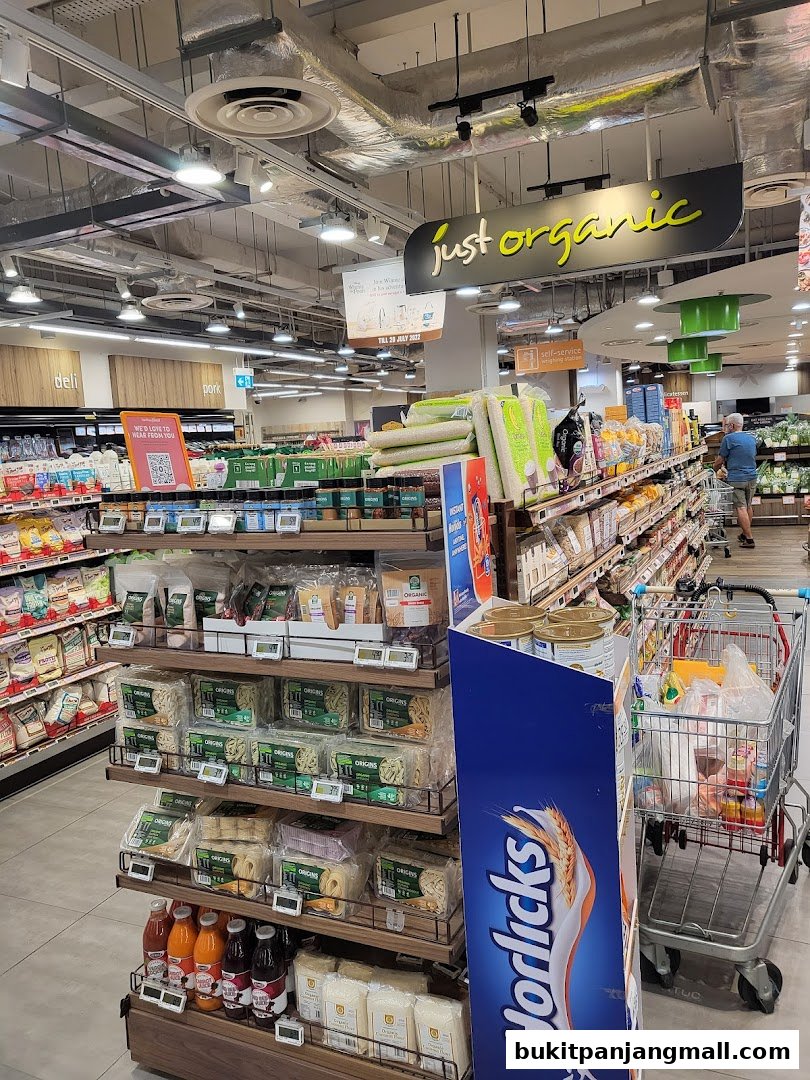 A well-stocked aisle in a FairPrice Finest supermarket featuring organic products and various food items.
