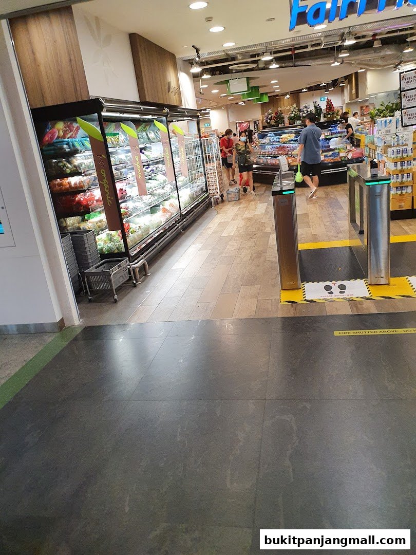 Interior view of a FairPrice Finest supermarket with fresh produce and shoppers.