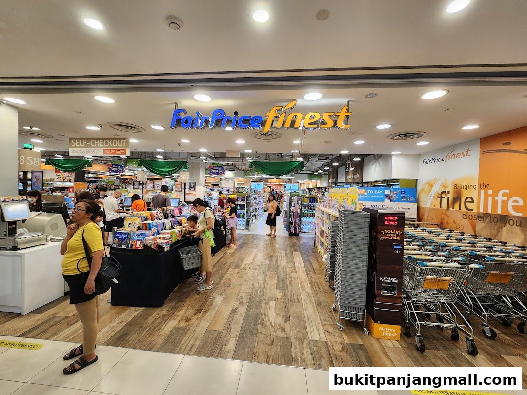 Interior view of a FairPrice Finest supermarket with shoppers and trolleys.