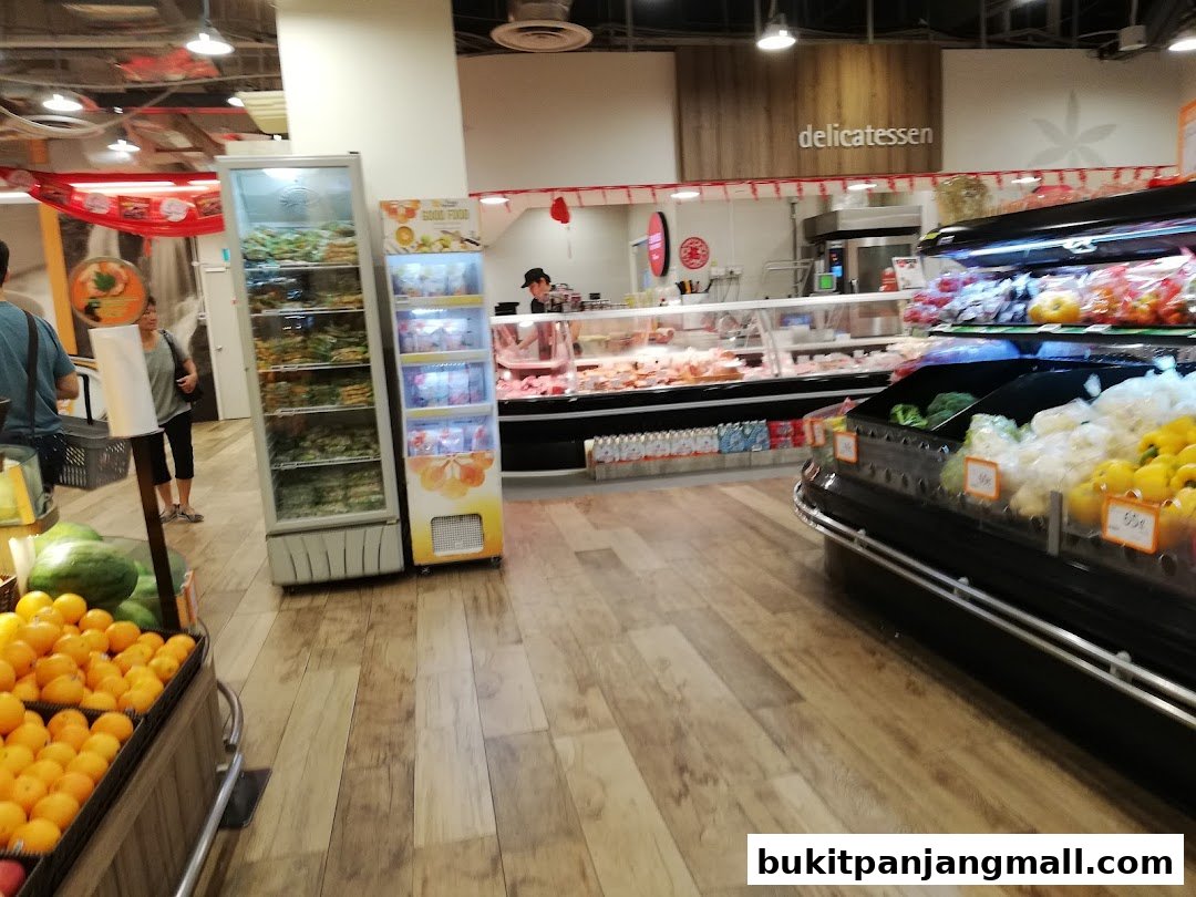 Interior view of a FairPrice Finest supermarket with fresh produce and a delicatessen counter.