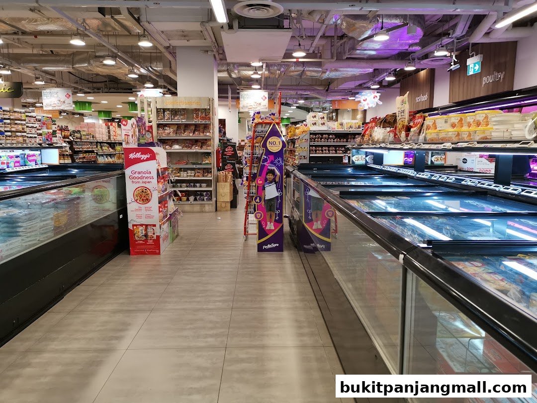 A wide aisle in a FairPrice Finest supermarket with frozen food displays and shelves stocked with groceries.