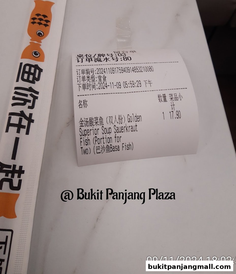 A receipt and chopsticks wrapper from Fish With You Bukit Panjang Plaza.